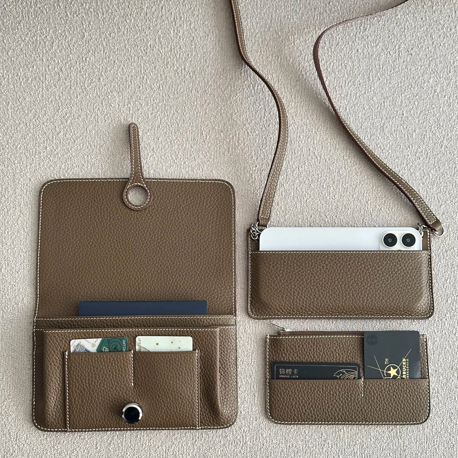 Brown leather wallet with multiple card slots and a phone holder on a light gray background